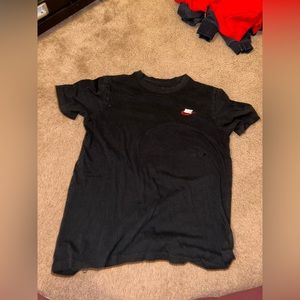 Black Nike T shirt side Medium, red and white Nike sign